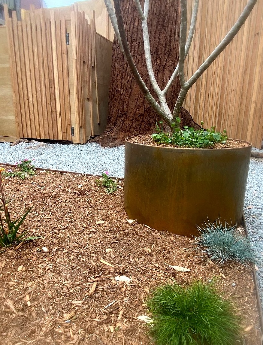 Corten steel planter with timber screening and textured garden planting